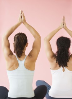 Two women exercising, studio shot.