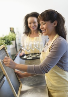 Two female business owners in restaurant.