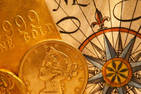 Antique map and coins, studio shot.