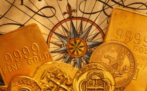 Antique map and coins, studio shot.