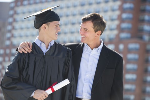 Father with teenage sun (16-17) at graduation ceremony.