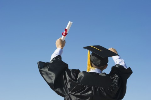 Teenage boy (16-17) at his graduation ceremony.