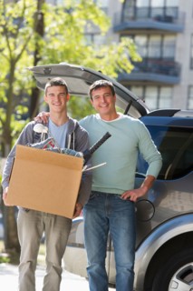 Father helping teenage son (16-17) packing to college.