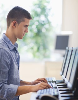 Teenage student (16-17) in computer lab.