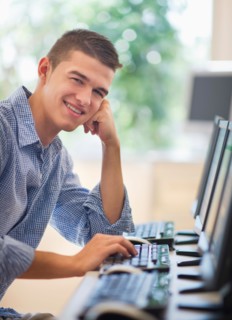 Teenage student (16-17) in computer lab.