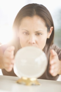 Woman looking into crystal ball.