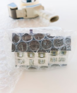 Studio shot of house wrapped in bubble wrap.