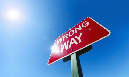 Low angle view of "wrong way" sign.