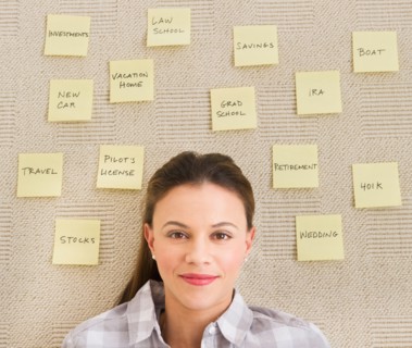 Woman lying on carpet with adhesive notes around head.