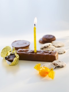 Studio shot of chocolate bars with birthday candle.