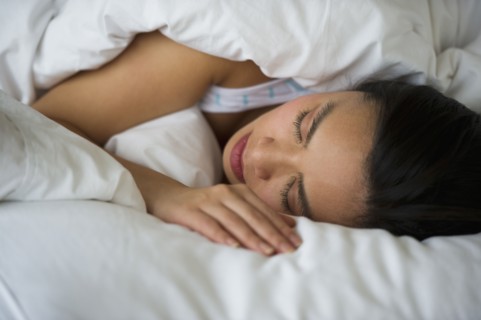 Woman sleeping in bed.