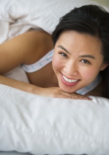 Woman lying in bed.