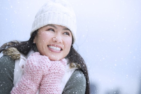 Portrait of happy woman wearing warm clothing.