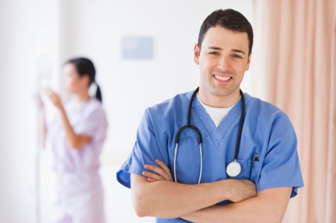 Portrait of doctor, nurse in background.