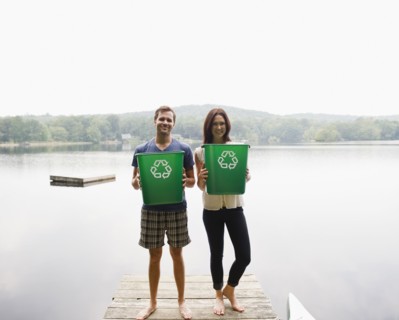 USA, New York, Putnam Valley, Roaring Brook Lake, Couple standing on pier with recycling bins.