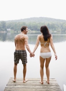 USA, New York, Putnam Valley, Roaring Brook Lake, Couple standing on pier by lake. Photo: Jamie
