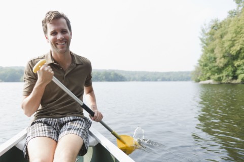USA, New York, Putnam Valley, Roaring Brook Lake, Man rowing boat. Photo: Jamie Grill