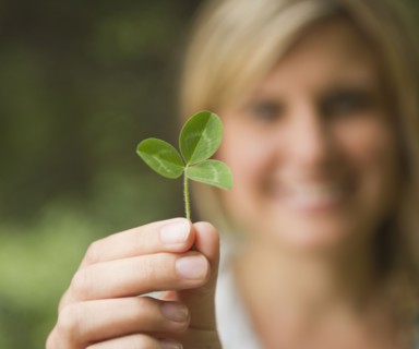 Roaring Brook Lake, Close up of woman's hand holding clover. Photo: Jamie Grill