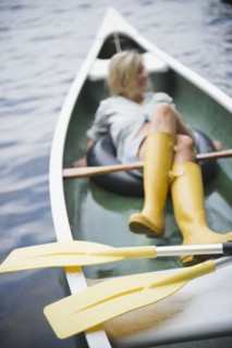 Roaring Brook Lake, Woman sitting in boat. Photo: Jamie Grill