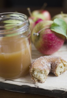 Close up apple cider, donut and apple on table. Photo : Jamie Grill