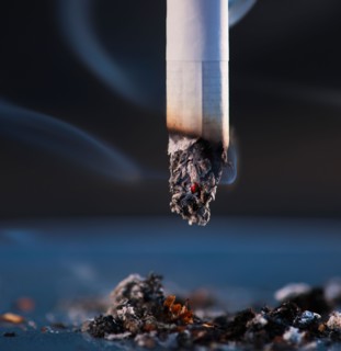 Close up of cigarette butt on black background. Photo : Daniel Grill