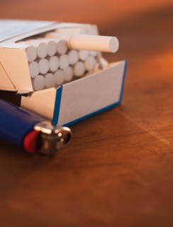 Close up of open cigarette pack and lighter. Photo : Daniel Grill