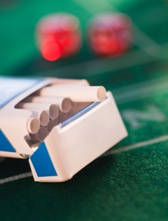 Close up of open cigarette pack on casino table. Photo : Daniel Grill