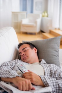 Man resting on sofa. Photo : Daniel Grill