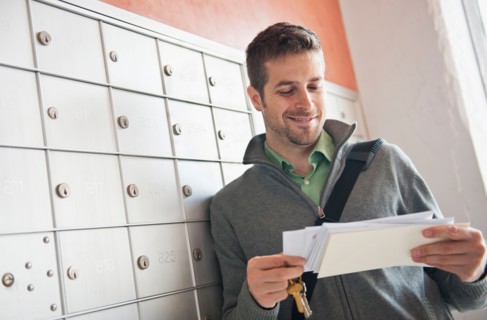 Man looking at correspondence. Photo: Daniel Grill