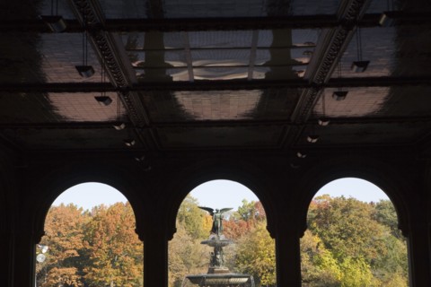 USA, New York City, Central Park, Bethesda Fountain with angel statue as seen through ach colonnade