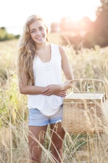 Outdoors portrait of teenage (16-17) with picnic basket . Photo: Take A Pix Media