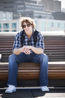 USA, Washington, Seattle, Young man sitting on bench. Photo : Take A Pix Media