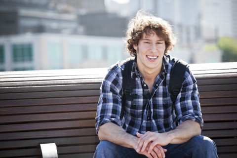 USA, Washington, Seattle, Young man sitting on bench. Photo : Take A Pix Media