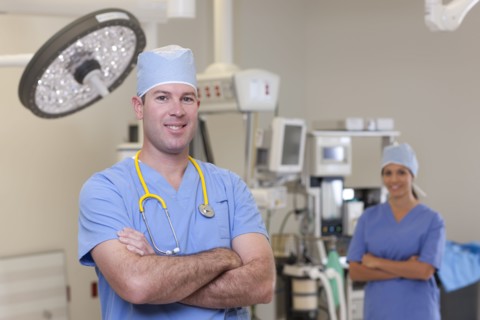 Portrait of male and female surgeons in operating room. Photo : db2stock