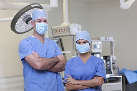 Portrait of male and female surgeons in operating room. Photo : db2stock