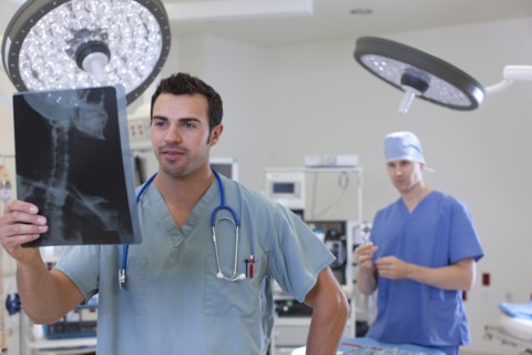 Doctor looking at x-ray. Photo : db2stock