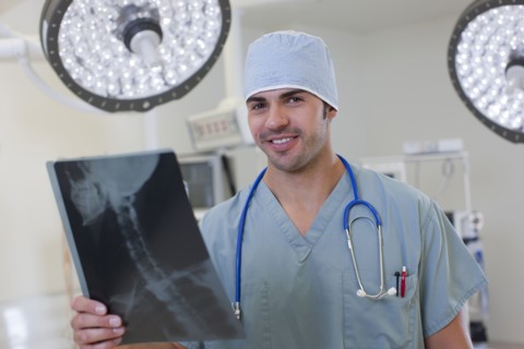 Portrait of doctor looking at x-ray. Photo : db2stock
