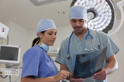 Surgeons looking at x-ray. Photo : db2stock