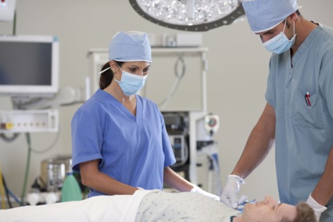 Surgeons preparing patient for surgery. Photo : db2stock
