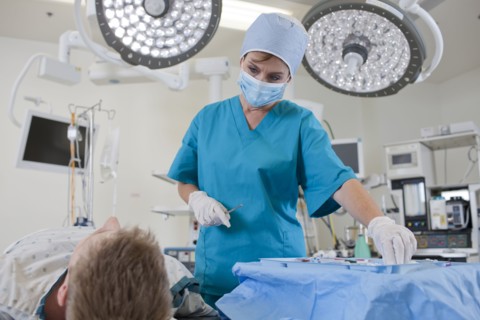 Surgeon preparing patient for surgery. Photo : db2stock