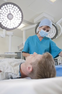Surgeon preparing patient for surgery. Photo : db2stock