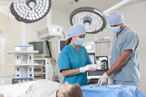 Surgeons preparing patient for surgery. Photo : db2stock