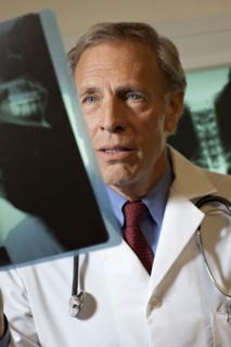 Doctor looking at x-ray. Photo : db2stock