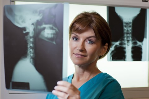 Portrait of female doctor looking at x-ray. Photo: db2stock