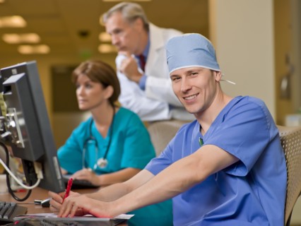 Doctor and surgeons working on computers in hospital. Photo : db2stock