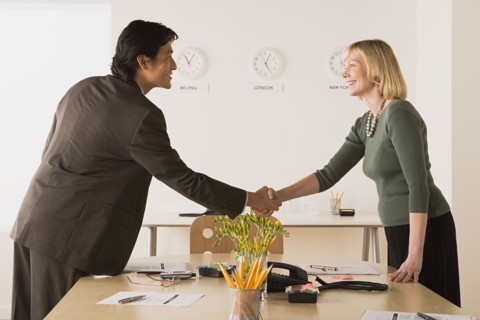 Business people shaking hands. Photo : Rob Lewine