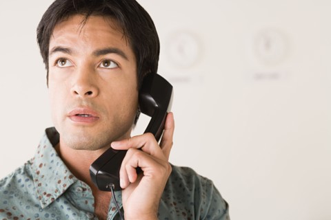 Businessman talking on phone. Photo : Rob Lewine