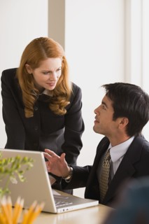Business man and woman talking. Photo: Rob Lewine