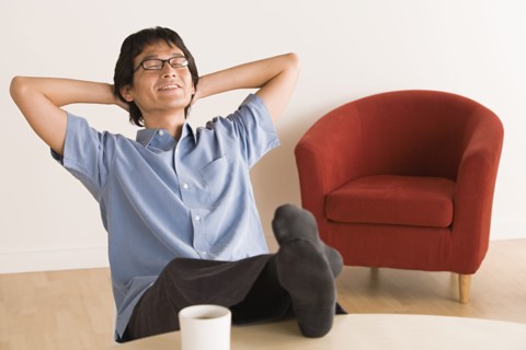 Man sitting with feet up on desk. Photo: Rob Lewine