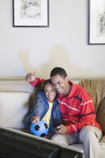 Father and Daughter (10-11) watching tv. Photo: Rob Lewine